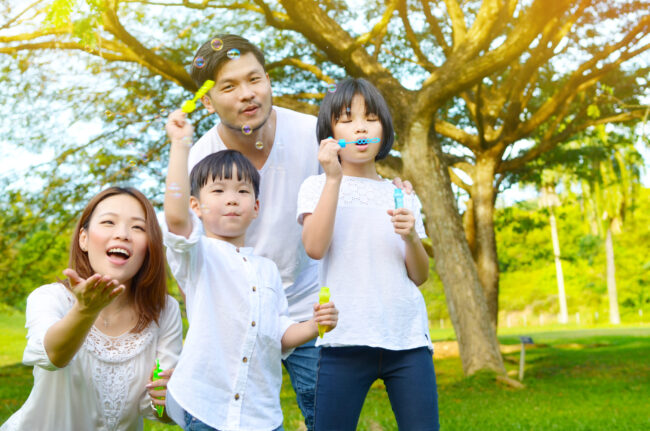 Happy,Asian,Family,Blowing,Bubbles,In,The,Park