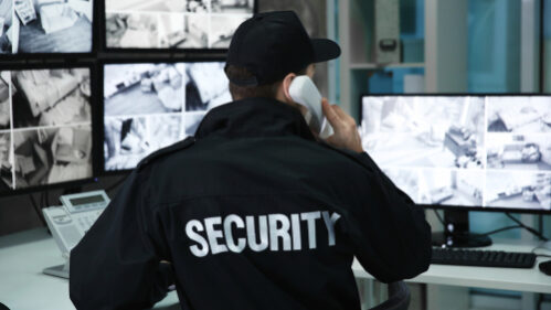 Male,Security,Guard,Talking,By,Telephone,In,Surveillance,Room